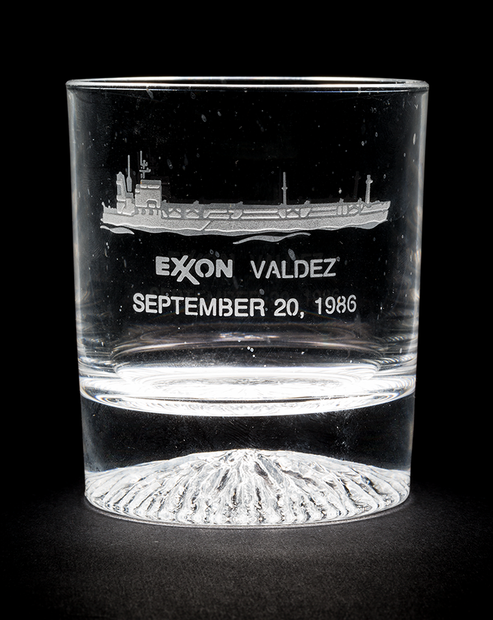 A high ball glass engraved with the image and name of the tanker Exxon Valdez along with the date September 20, 1986.