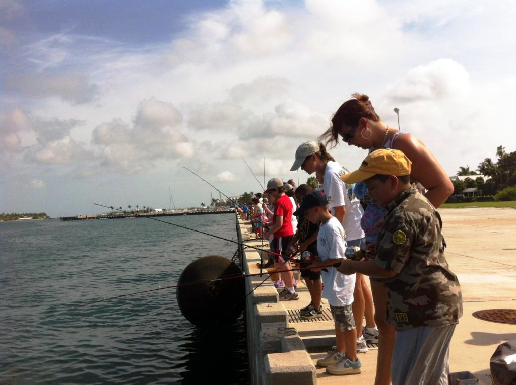 People fishing off a pier. 