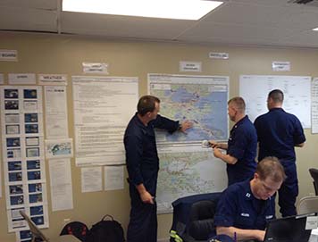 NOAA's Lieutenant (junior grade) Kyle Jellison describing the location of oil spill sites to the U.S. Coast Guard Situation Unit inside the Hurricane Isaac command post in New Orleans, La.