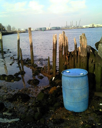 Blue drum at water's edge after Sandy in New York.