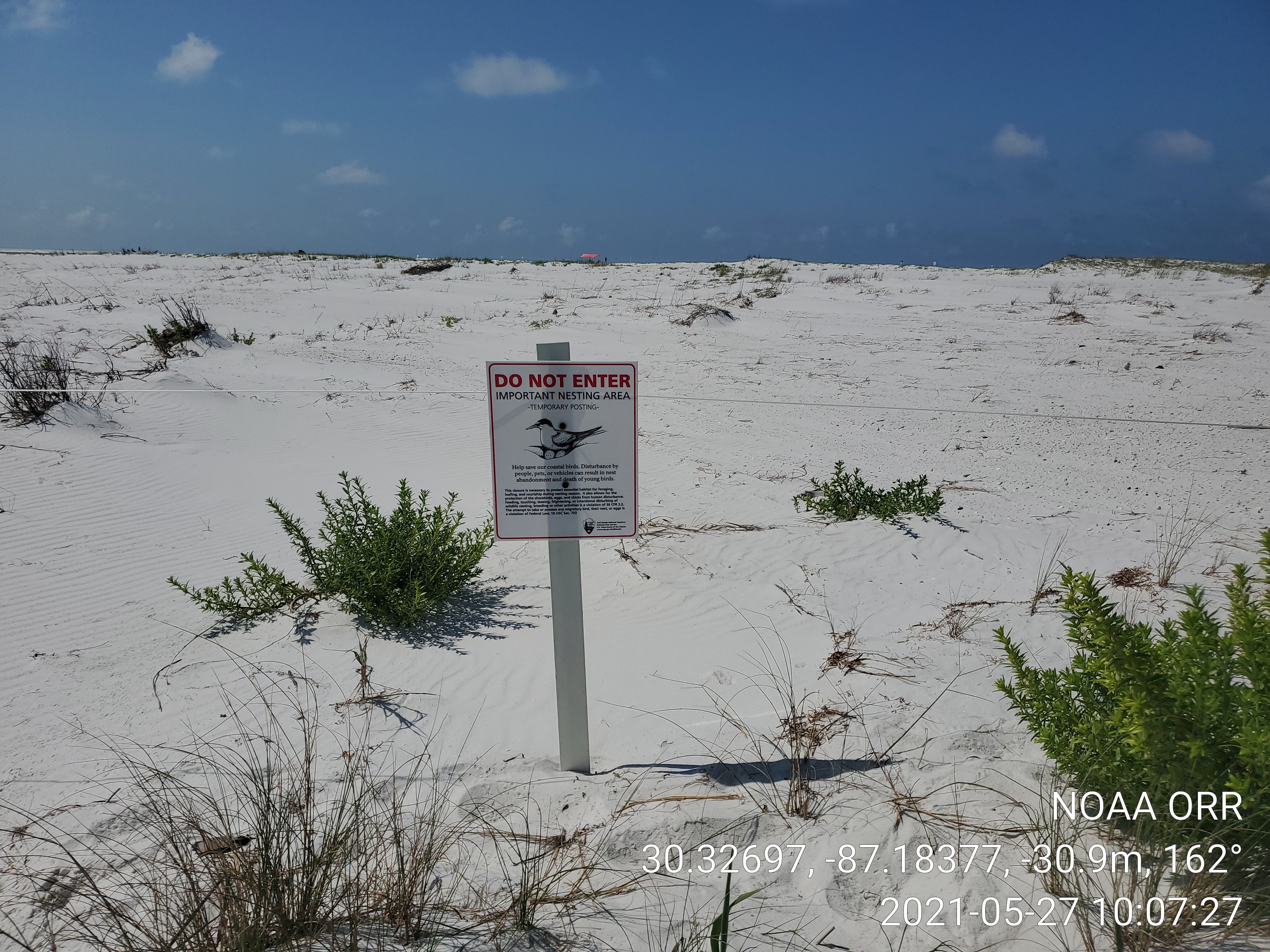 A "do not enter" sign on a beach.
