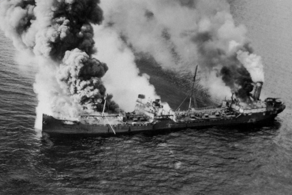 A black and white photo of smoke billowing from a vessel.