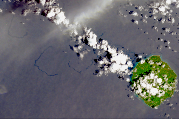 Satellite image of island, clouds, and oil (appearing as snake-like lines).