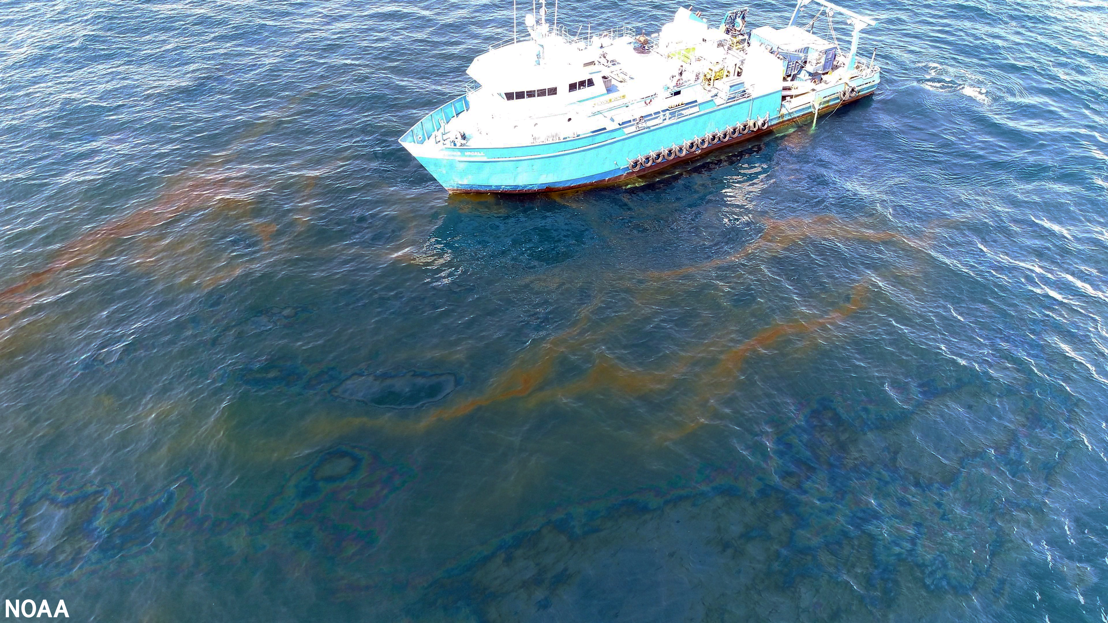 An aerial image of a vessel near spilled oil.