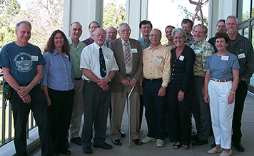 Group of people standing around Don Reish.