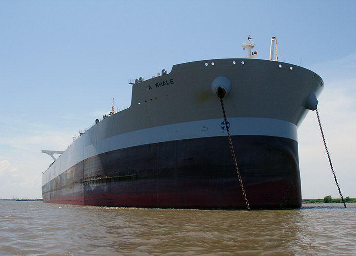 A super tanker ship with a large slit in the bow anchored in the Gulf of Mexico.