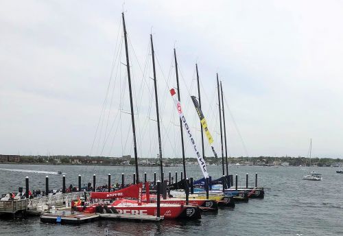 Sailboats in a line at a dock. 