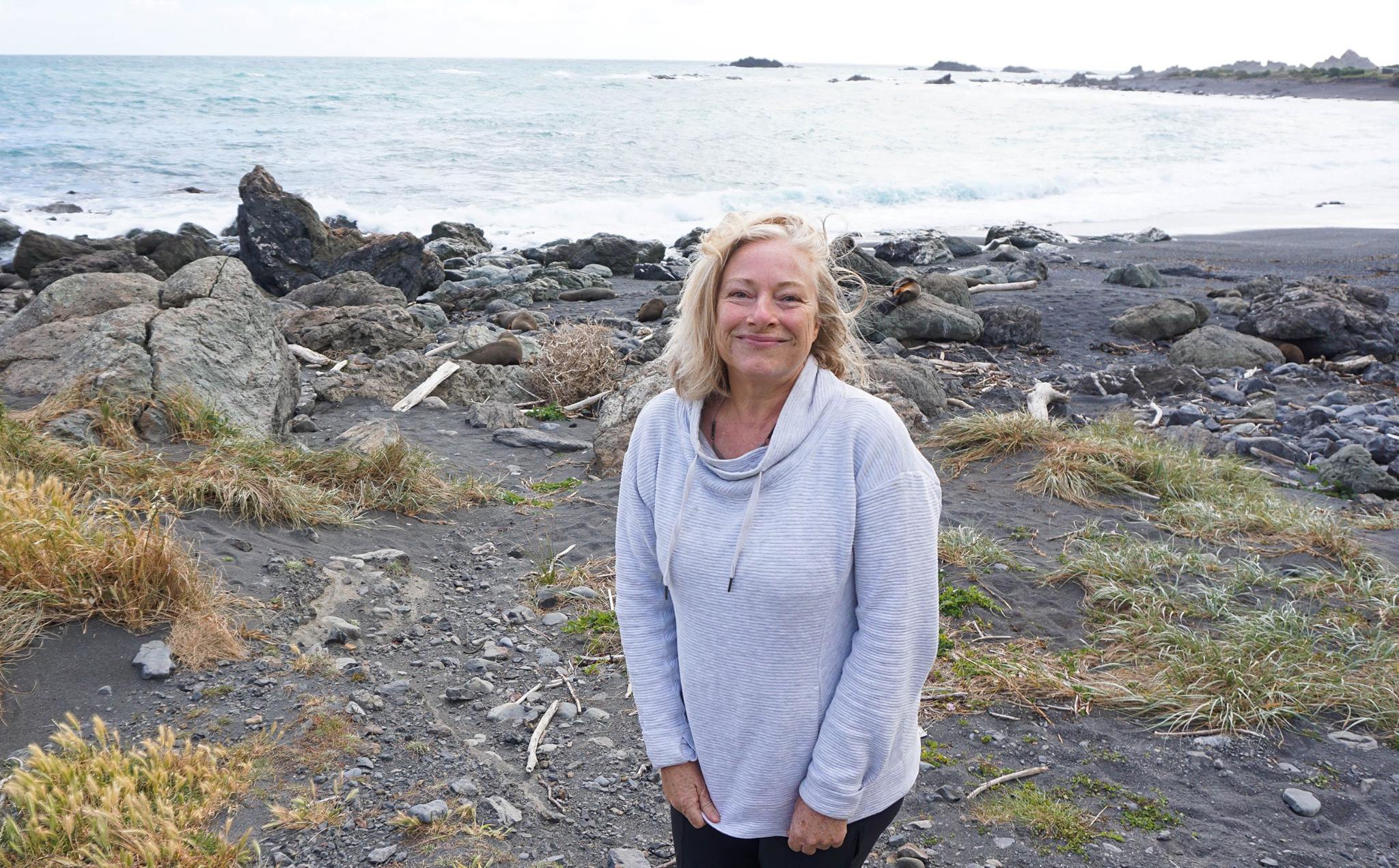 Woman posing on a beach.