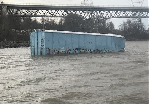 Rail car floating in a river. 