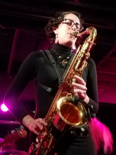 A woman playing a saxophone. 
