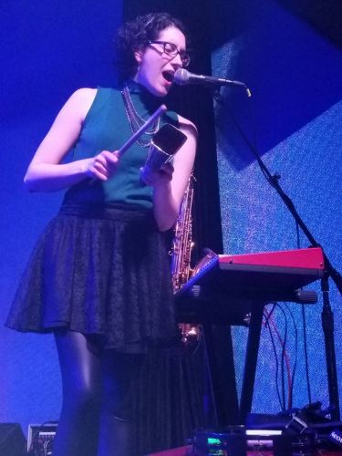A woman singing into a microphone. 