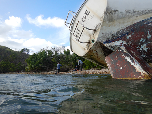 Beached vessel on its side.