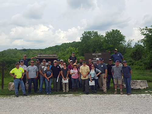 Group posing for photo outdoors.