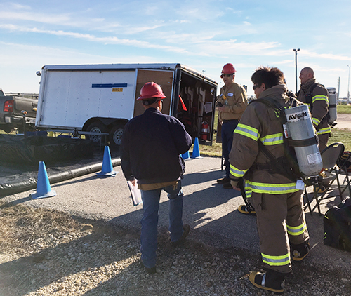 Group of people in hazmat gear.