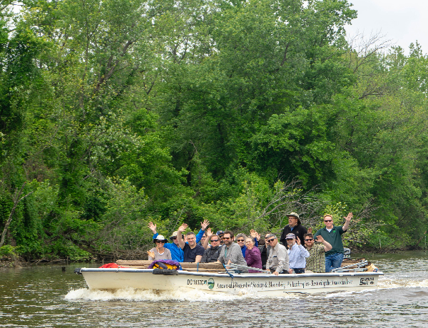 Group of people in a boat on a river.