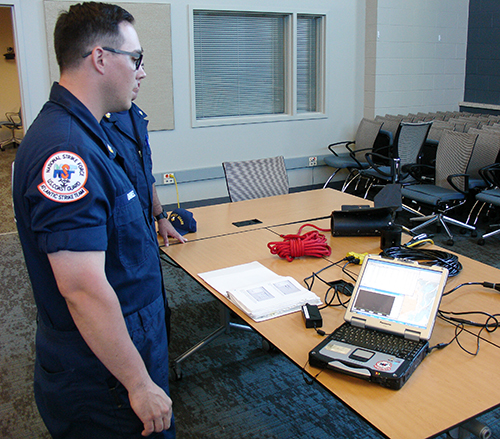 Man standing next to a table with equipment.