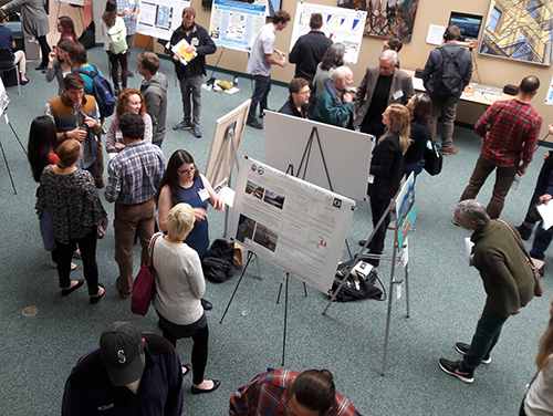 Group of people milling about in an exhibit hall.