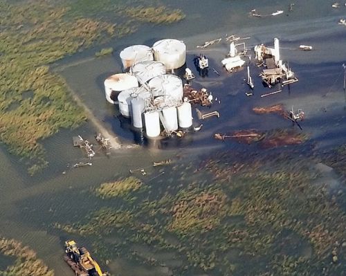 An aerial image of oil in a flooded marsh area coming from an oil facility.