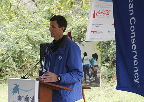 Man speaking at a microphone.