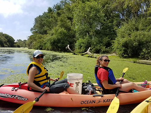 Two people in a kayak on the water.