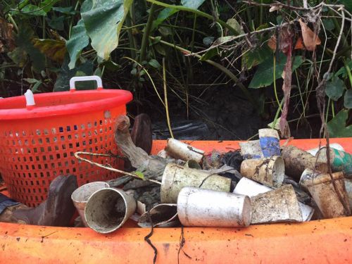 Basket and debris, including Styrofoam cups.