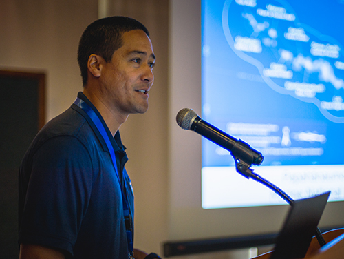 Man speaking into a microphone.