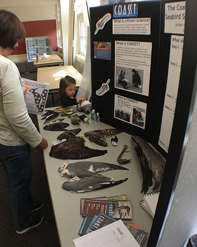 People gathered around a display. 