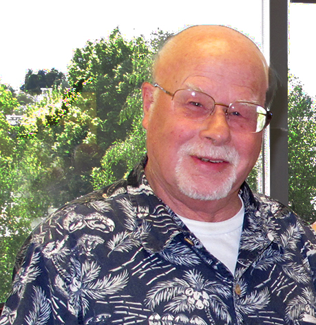 Man posing in front of a window.