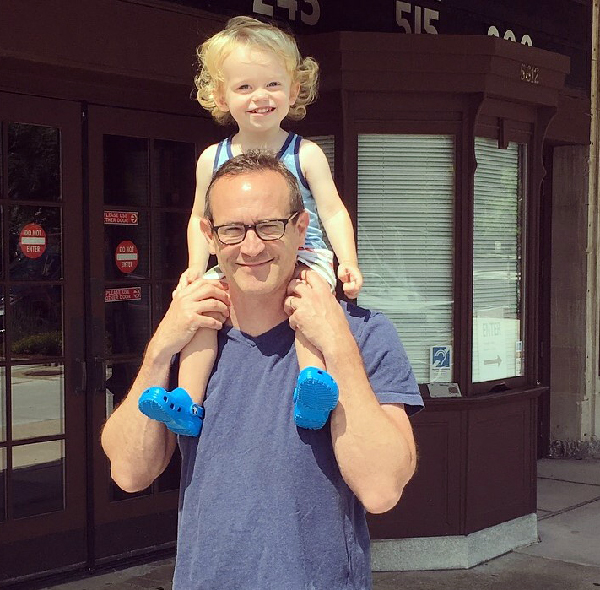 Man with small child on his shoulders. 