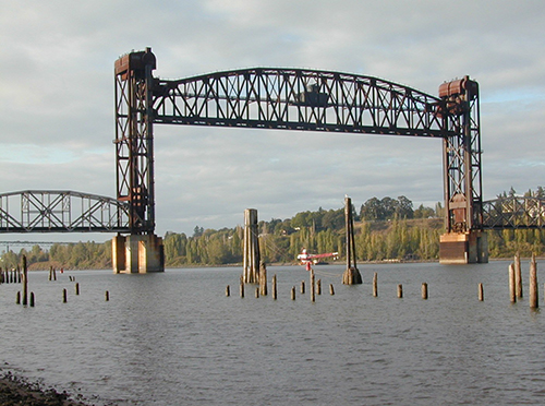 Tall bridge over a waterway. 