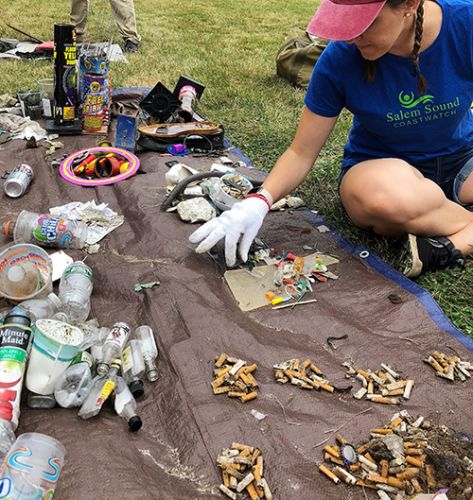 Woman with small piles of debris.