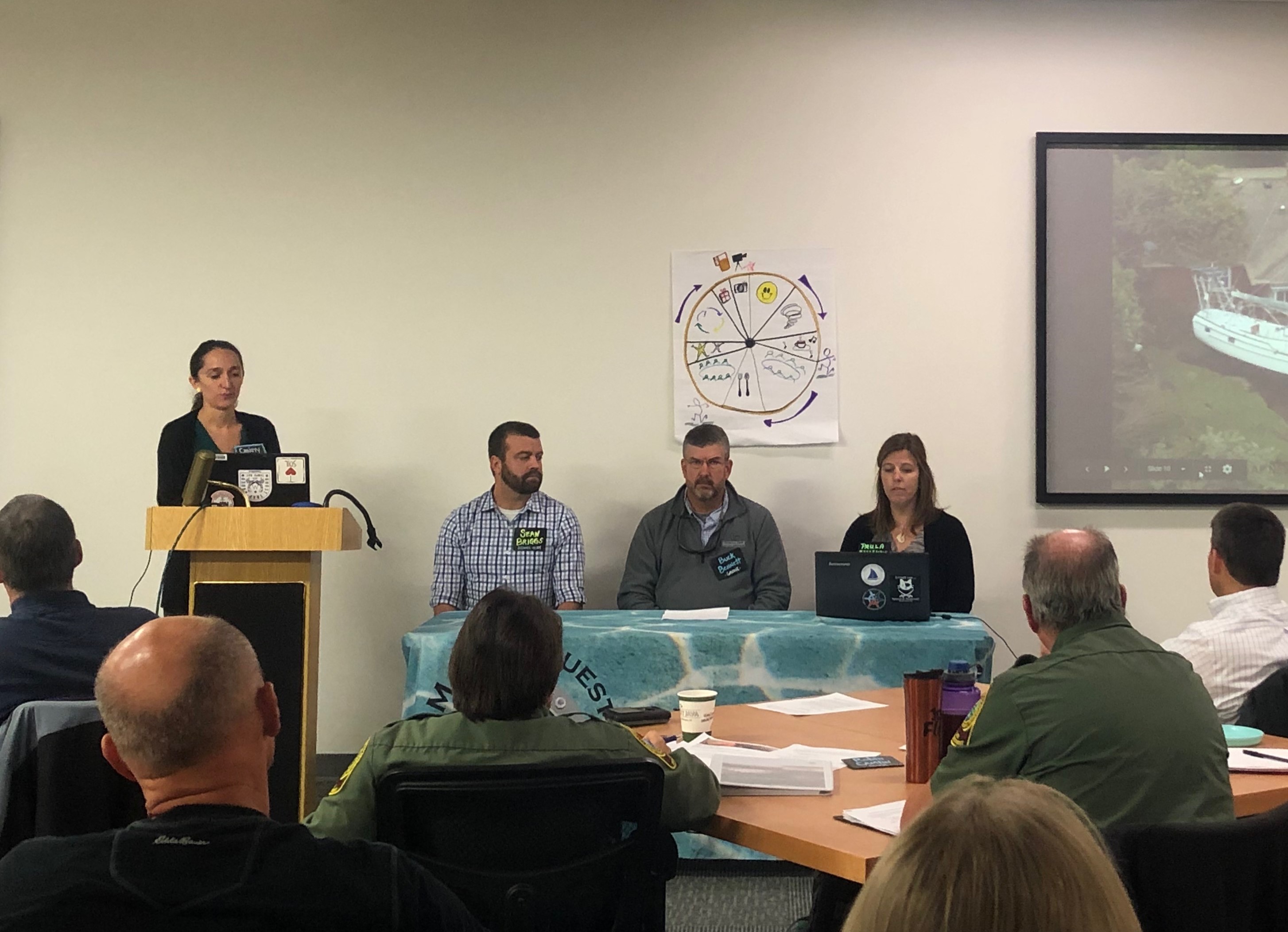 Panelists speak to people in a room.