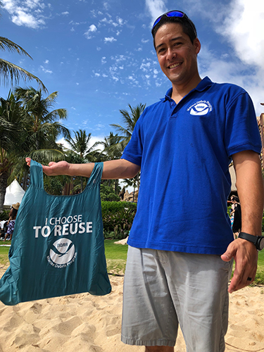 Man posing for photo with bag.