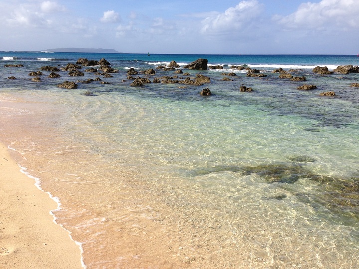 View of shoreline, beach and rocks.