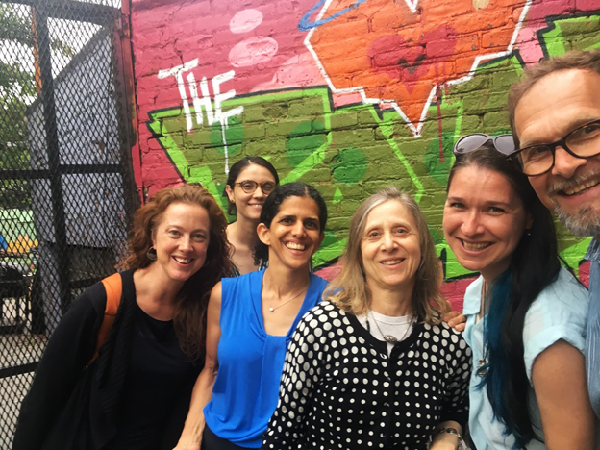 Group of six people pose for photo.