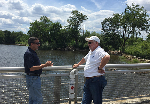 Two men talking on a pier.