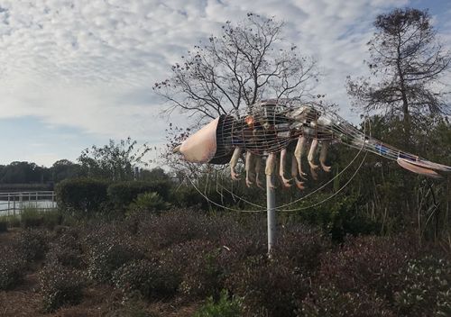 Photo taken outdoors of large shrimp sculpture.