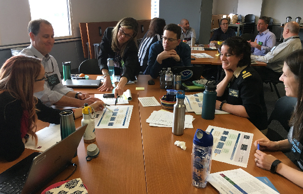 Group of people meeting around a table.