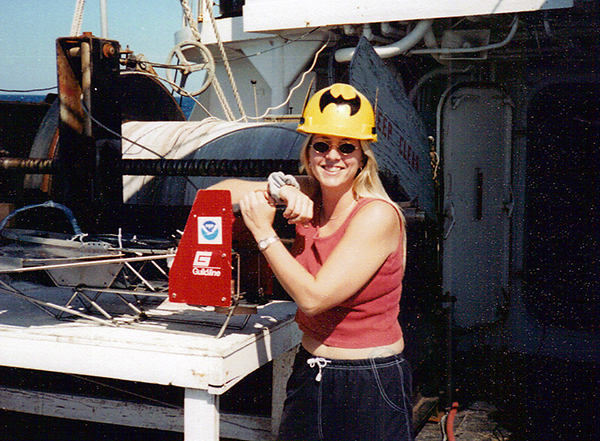 Woman posing on a research vessel.
