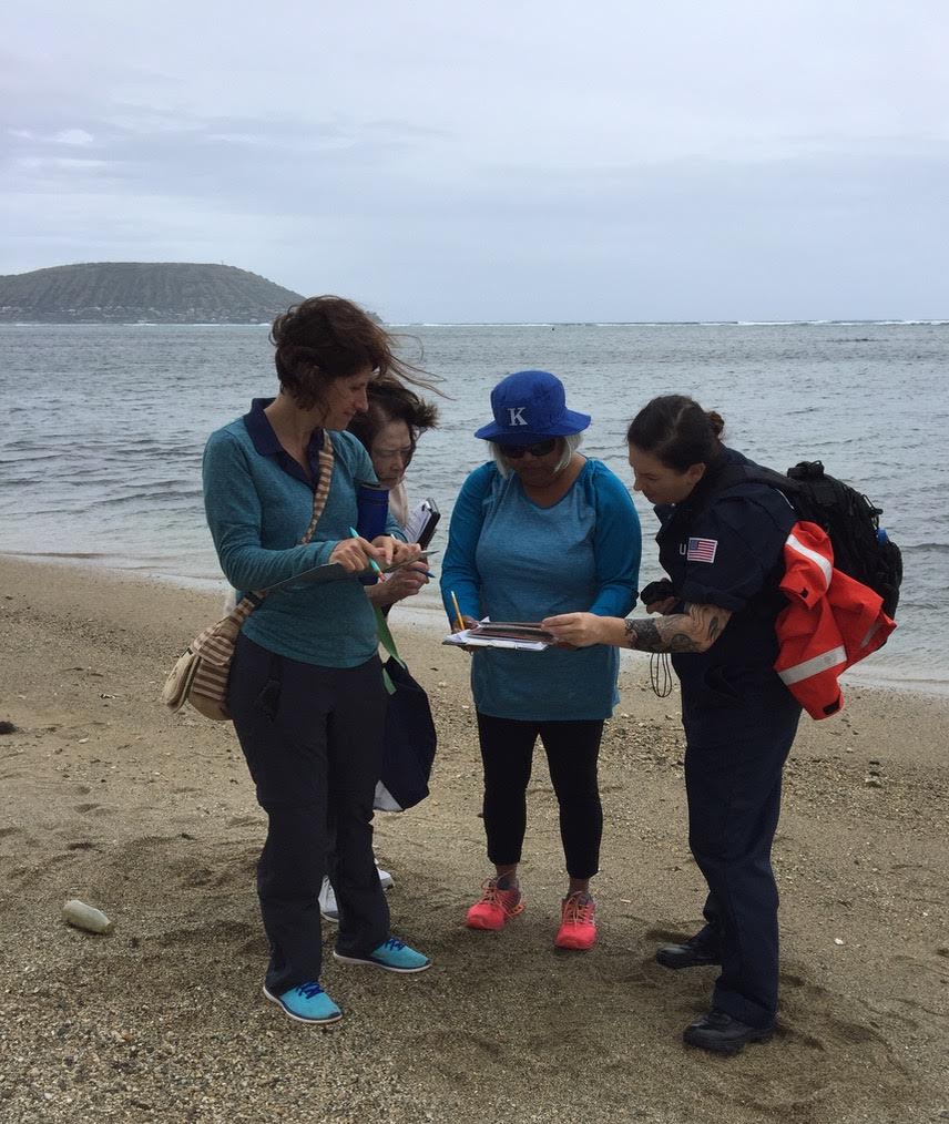 Four people gathering on a beach.