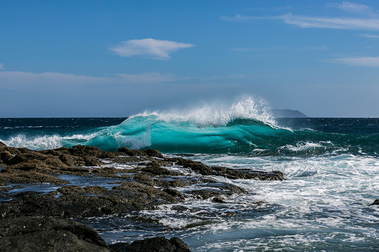 Wave breaking on rocks.