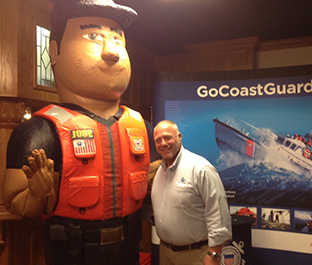 Man with giant inflatable Coast Guard mascot.