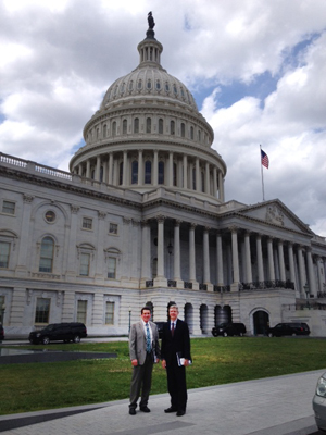 Two men in front of U.S. Capitol.