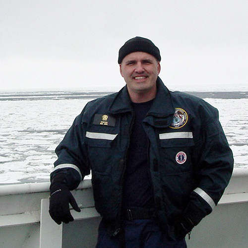 Photo of a man in uniform on a boat.