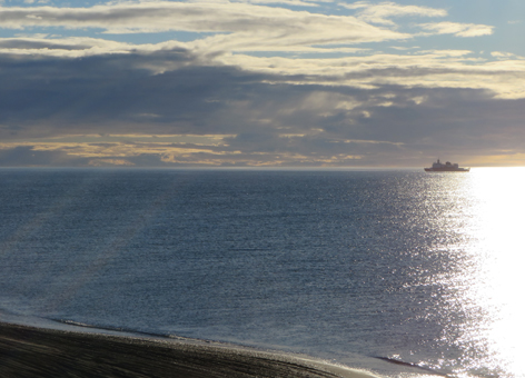 Ship on the horizon of the ocean.