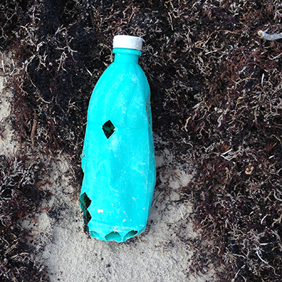 Discarded plastic bottle on the beach