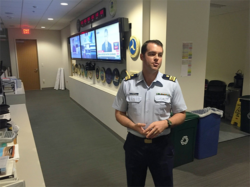 Man in uniform standing in hall.
