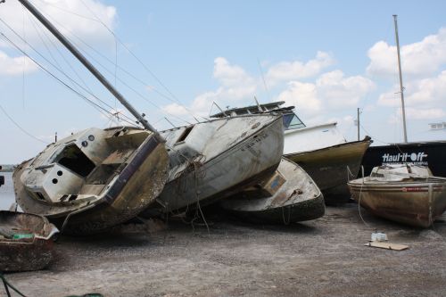 Boats stacked up on the ground.