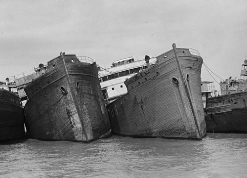 Old image of ships in a row, listing.