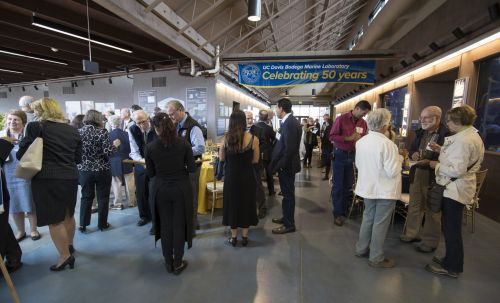 People milling about in a large hall.